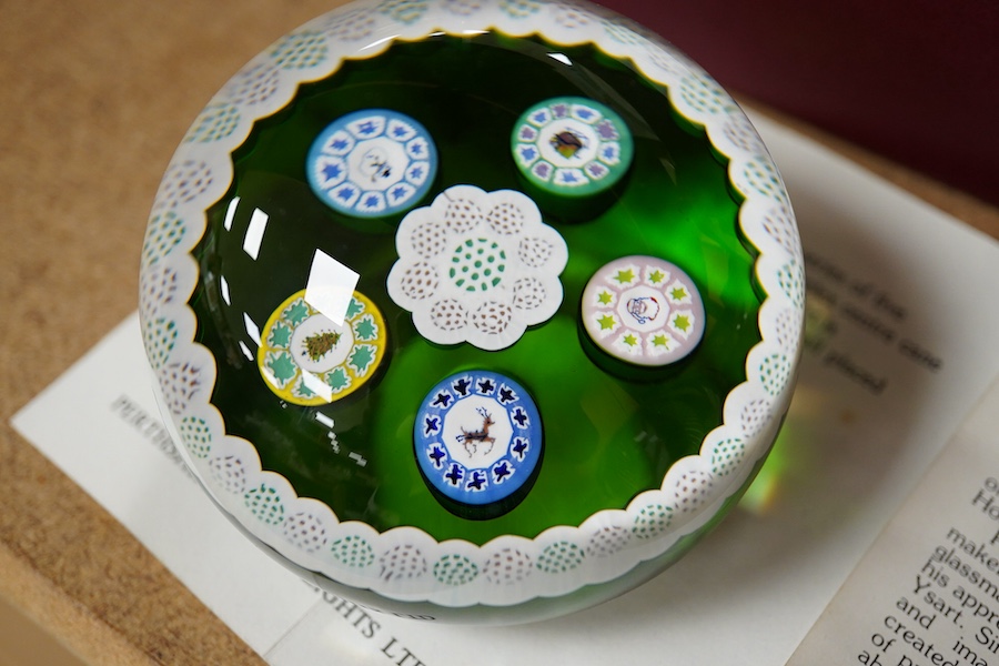 Two Perthshire glass Christmas paperweights for 1981 and 1983, a Perthshire miniature Latticino weight, 18/400, dated 1982, and a Selkirk glass Millefiori crown paperweight, 1982, (4) Largest Perthshire paperweight 8cm